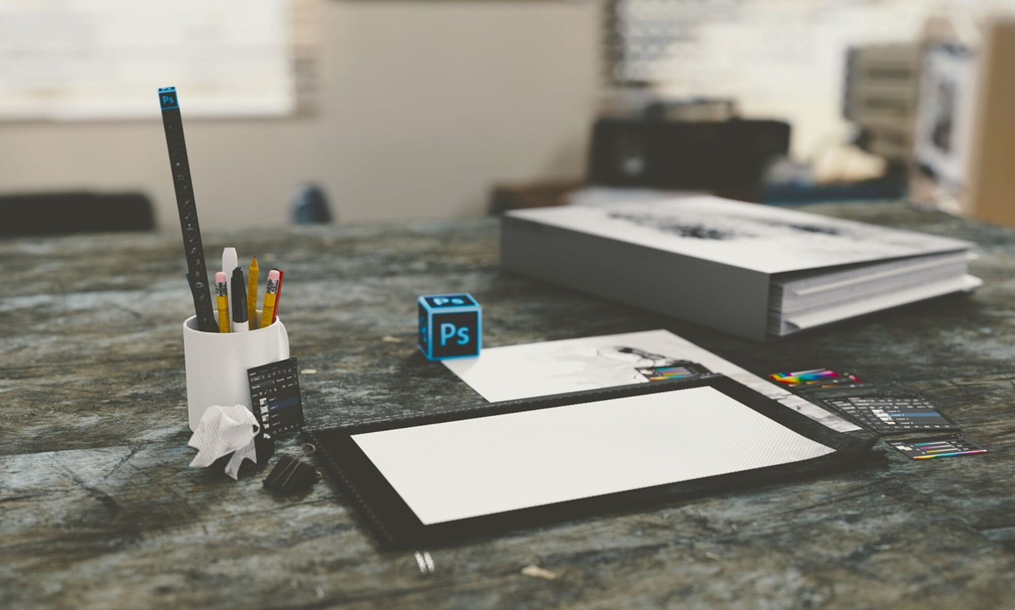 Office desk with Photoshop cube on top